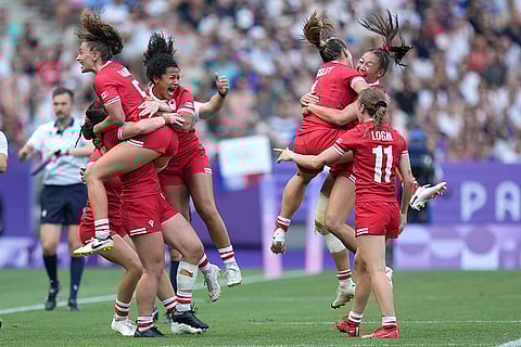 Canadian team celebrate after winning the women's semifinal Rugby Sevens